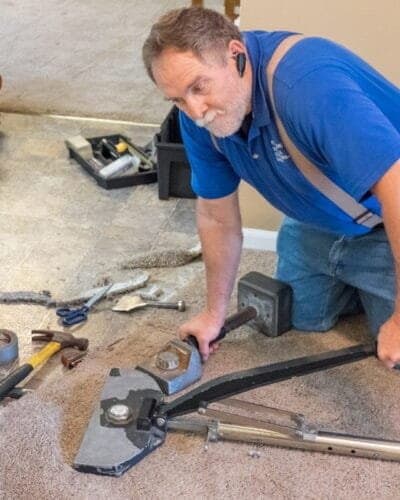 Stretching carpet with power stretcher repairs